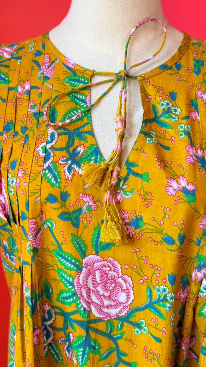 Ladies Nighties _ Mustard-Golden Yellow Base with Dense Floral in Soft Pink Roses and Rose-Like Blooms, Mixed with Smaller Pink Buds and Flowers. The Foliage is in Shades Of Green