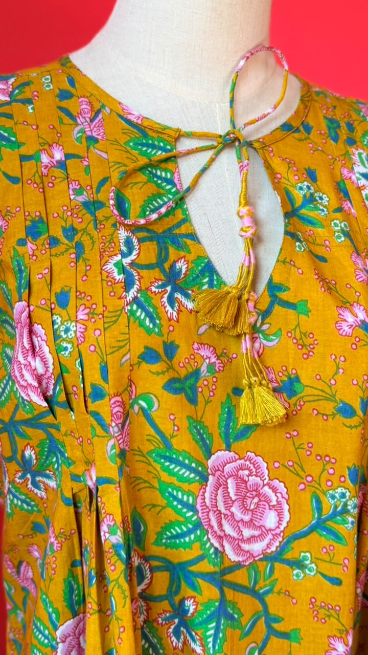 Ladies Nighties _ Mustard-Golden Yellow Base with Dense Floral in Soft Pink Roses and Rose-Like Blooms, Mixed with Smaller Pink Buds and Flowers. The Foliage is in Shades Of Green